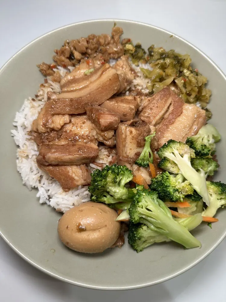 Braised pork belly over rice with a marinated egg and broccoli