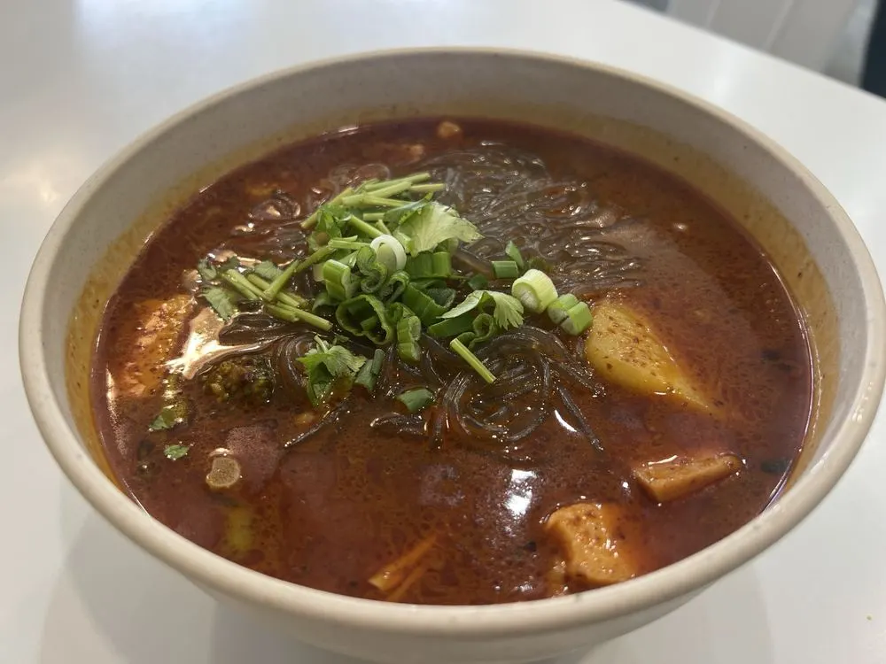 Malatang with glass noodles, potato, and cilantro in a red broth