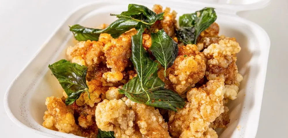 Salt and pepper popcorn chicken with fried basil leaves